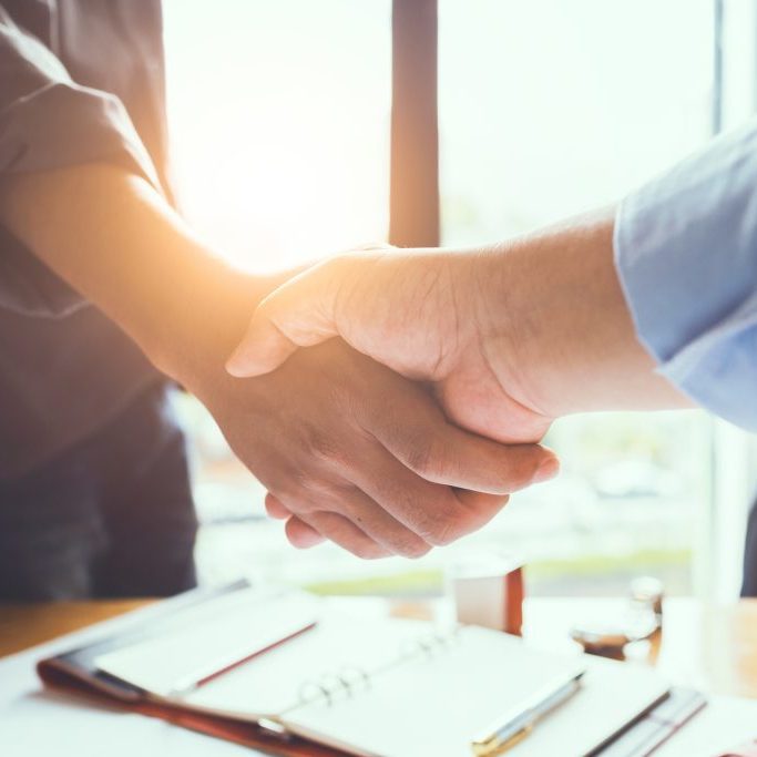 Business engineer team shaking hands to agree to joint business agreements in the future. About the creation of real estate and housing projects for government projects.